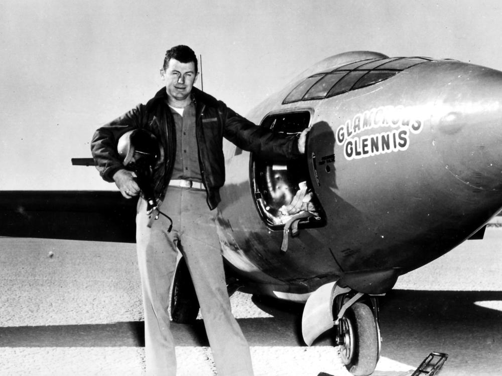 Chuck Yeager, standing next to the 