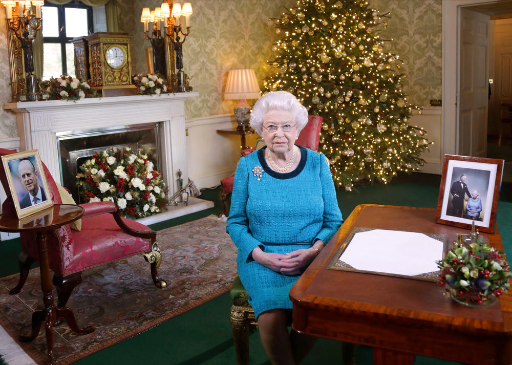 Queen Elizabeth II sits at a desk in the Regency Room after recording her Christmas Day broadcast at Buckingham Palace on Dec. 24, 2016, in London.