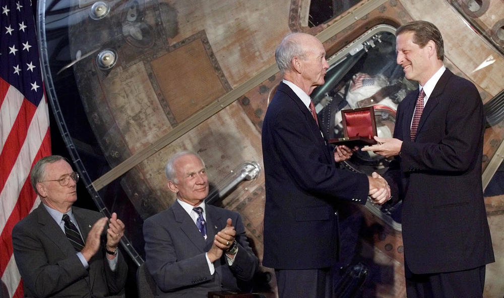 Collins receives an award for aviation from Vice President Al Gore in 1999 at a ceremony at the National Air and Space Museum. Fellow Apollo 11 astronauts Armstrong (left) and Aldrin also were honored at the event marking the 30th anniversary of the first moon landing.