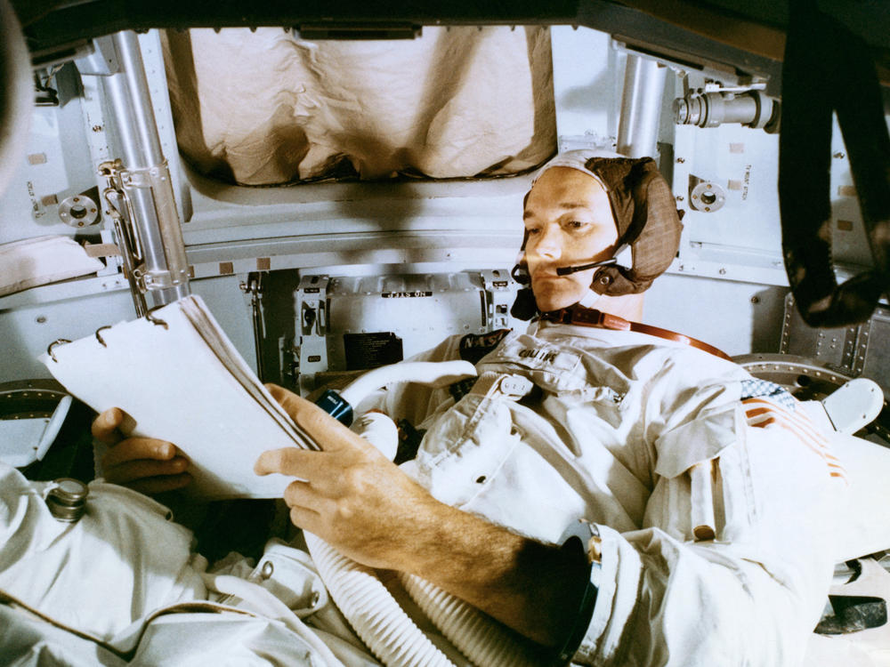 Collins studies the flight plan during simulation training at the Kennedy Space Center before the scheduled Apollo 11 mission.
