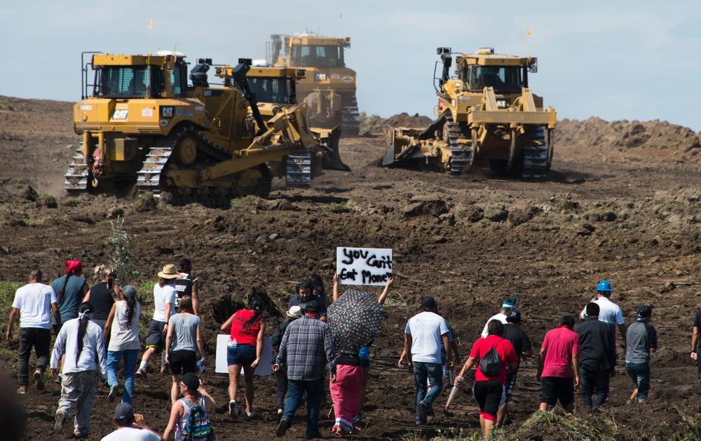 Protestors approach construction crews during a demonstration against work being done for the Dakota Access Pipeline near Cannon Ball, N.D., on Sept. 3, 2016.