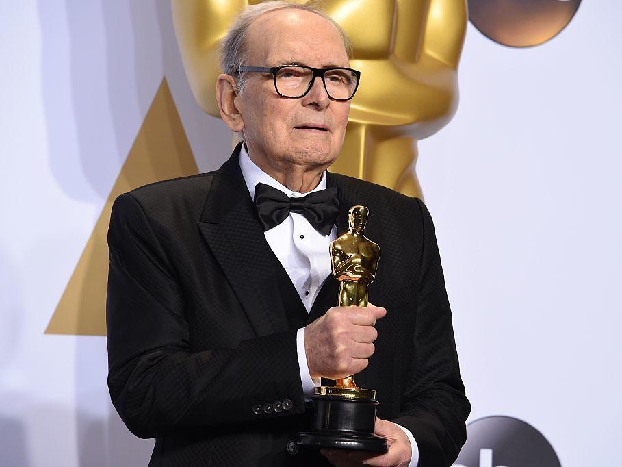 Composer Ennio Morricone, posing with his Oscar for <em>The Hateful Eight </em>in 2016. He died Monday at age 91 in Rome.