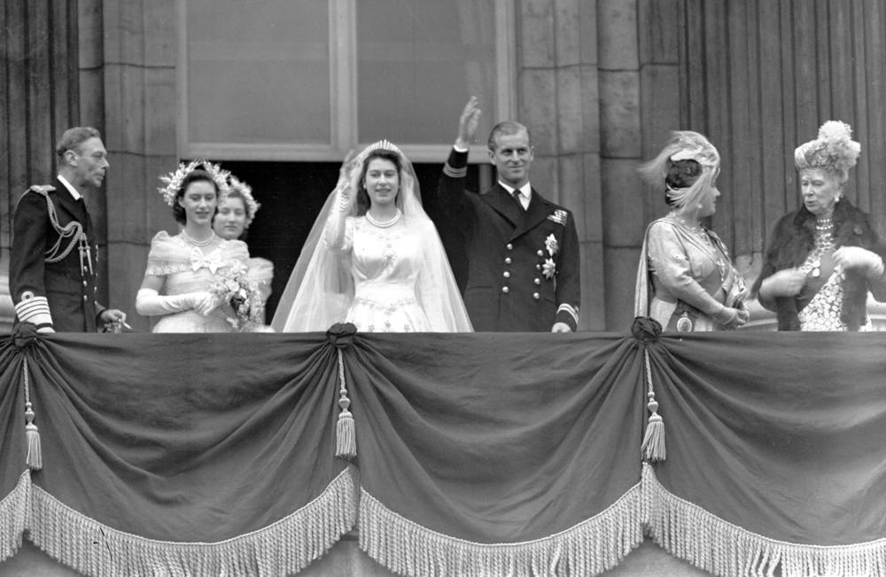 Britain's Queen Elizabeth II, then Princess Elizabeth, and Prince Philip, the Duke of Edinburgh, wave to the crowd from the balcony of Buckingham Palace after their wedding on Nov. 20, 1947. From left are King George VI, Princess Margaret, Lady Mary Cambridge, the bride and groom, Queen Elizabeth and Queen Mary.