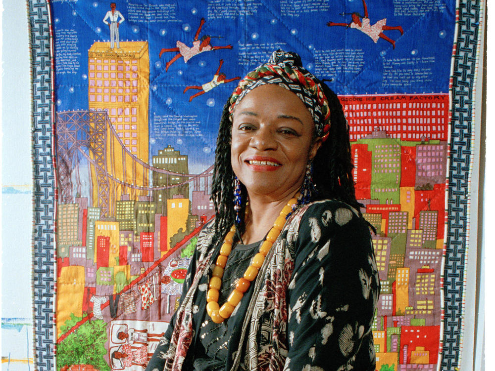 Artist Faith Ringgold sits before her quilt 
