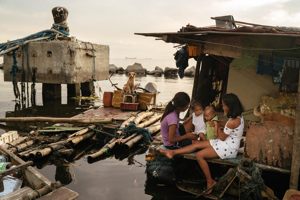 Sisters Joan (left) and Jossa Garcia (right), both teen mothers, are seen in their home in the Navotas fish port with their children, Angela and JM, respectively.