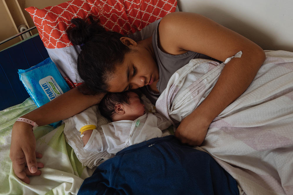 In November 2019, 18-year-old Ralyn Ramirez curls up with her second child, a boy. In between giving birth, she had warned other teens about having a baby.