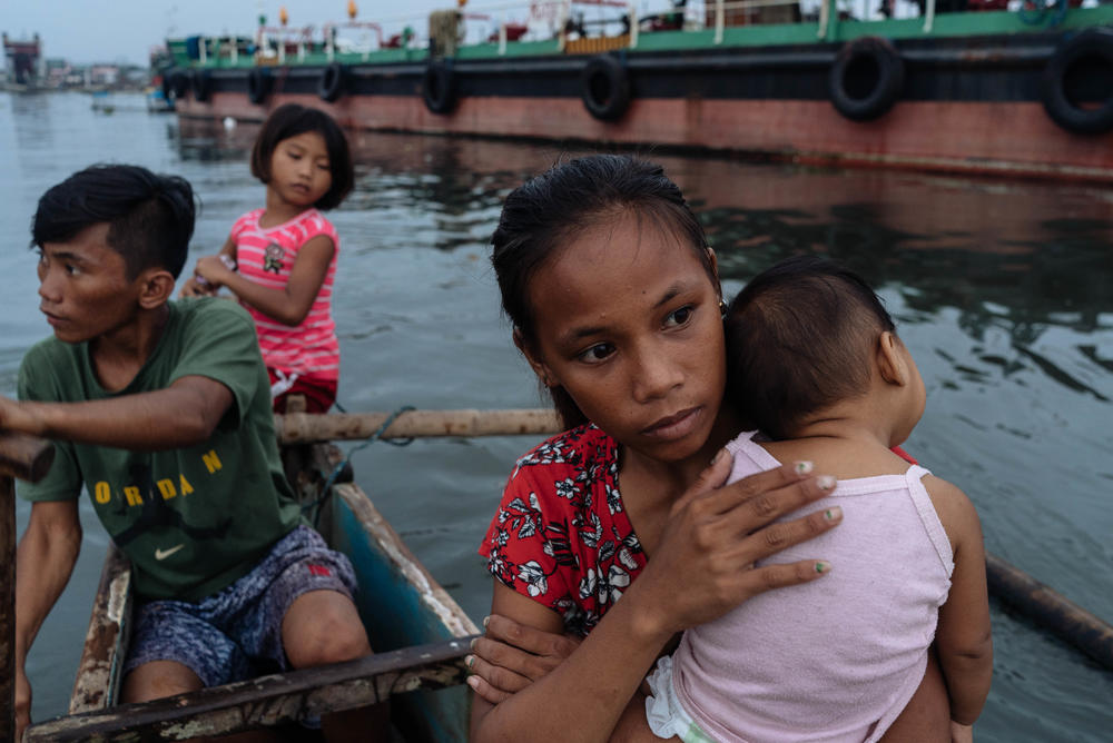 Joan Garcia (right) and her baby take a boat ride home. Garcia says she's embarrassed to play kids' games now that she's a mother — but admits 