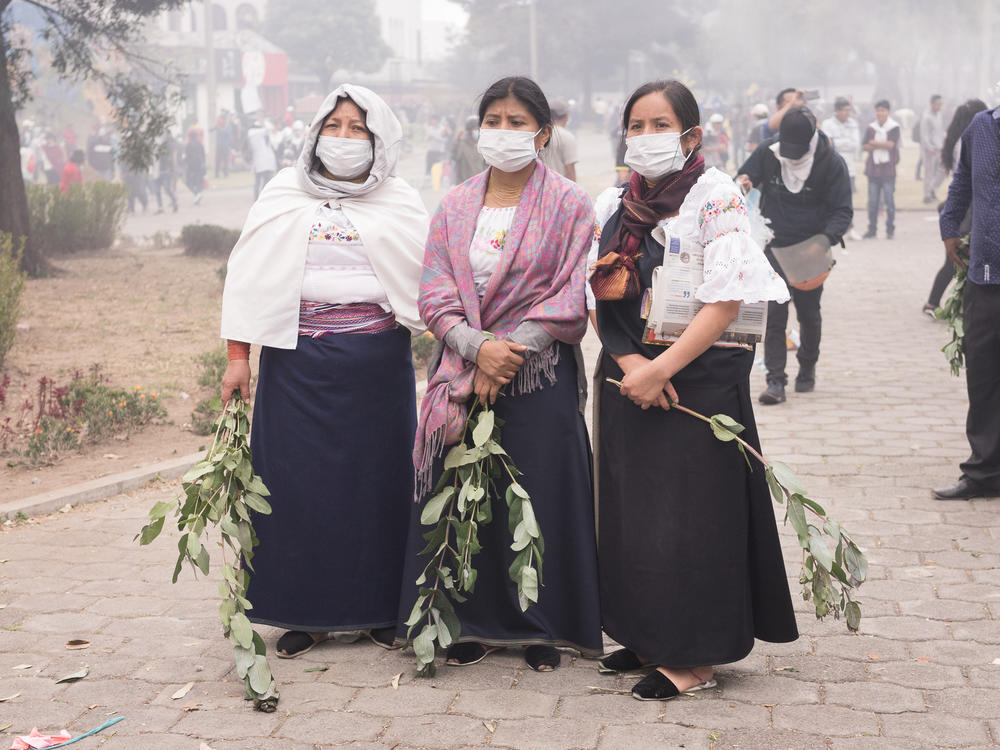 Tree women of the Otavalo indigenous community of Ecuador stand on the Arbolito park in Quito, Ecuador during the 10th day of social protests that took place in October, 2019.