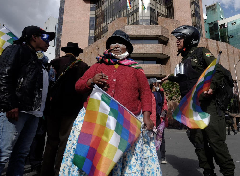 A Bolivian woman smokes after being attacked by teargas used by the police to control and suppress the protest. Bolivians went to the streets to call for the resignation of interim president Jeanine Añez Chávez in November, 2019.