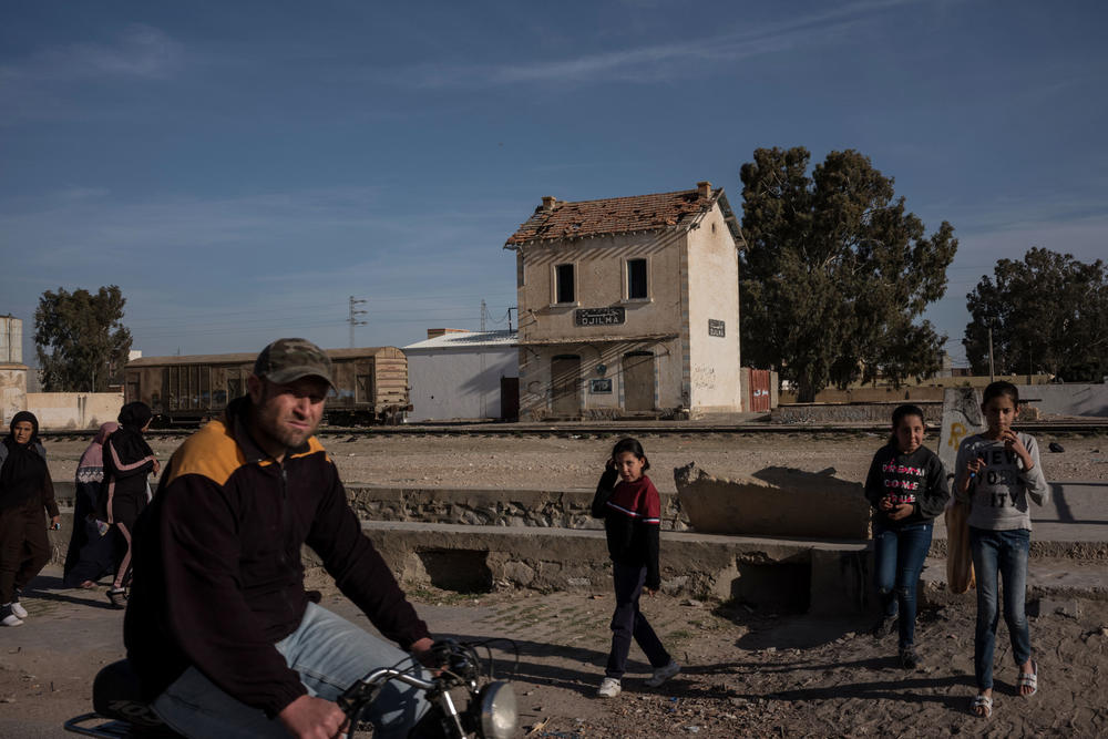 Residents of Jelma, Tunisia are seen near the town's abandoned train station on February 29. Jelma is located about 21 miles from Sidi Bouzeid, where in 2011 Mohamed Bouazizi died after setting himself on fire. His death kicked off popular youth-led protests and ultimately, the Arab Spring.