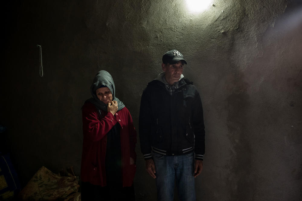 The parents of Abdelwaheb Hablani, Fouzia Araissi (left) and Jilani Hablani, stand in their home in Jelma.