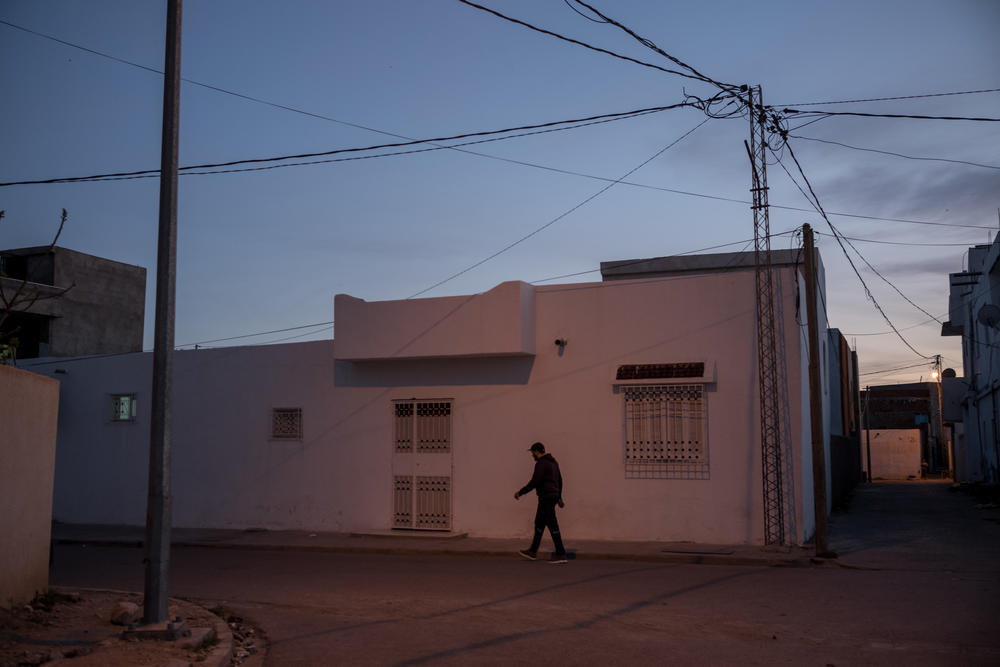A man walks down a street in Jelma. Jelma is one example of the many interior towns of Tunisia suffering from high unemployment rates and overall lack of development.