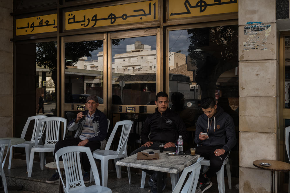 Ahmed Ferjeni (center), 25, sits at a cafe with a friend in Sousse, after going to the employment agency to try and apply for a job. Ahmed trained as a mechanical engineer but has had trouble finding a job in his field.