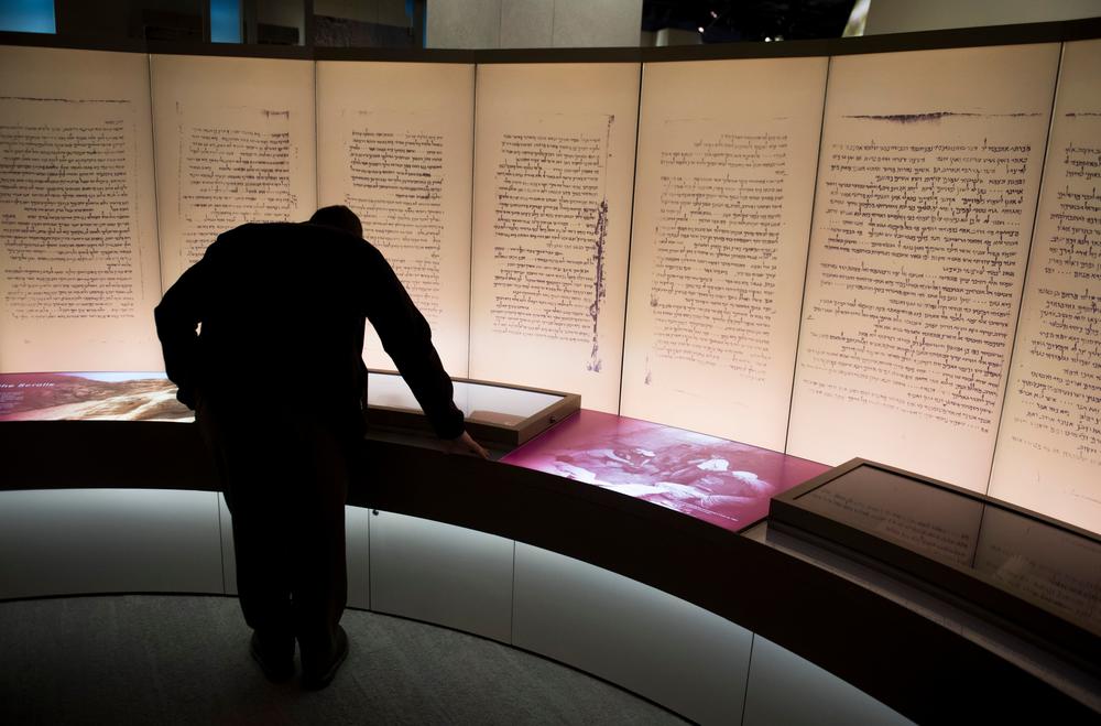 Visitors look at an exhibit about the Dead Sea Scrolls during a media preview of the Museum of the Bible in 2017. In March of this year, the museum announced that one of its prized possessions — purported fragments of the Dead Sea Scrolls — had been found to be modern forgeries.