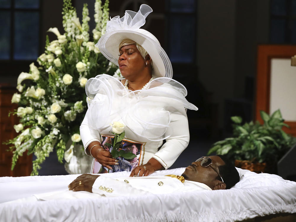 Tomika Miller weeps over her husband Rayshard Brooks as his coffin is closed at the conclusion of his public viewing at Ebenezer Baptist Church in Atlanta on Monday.