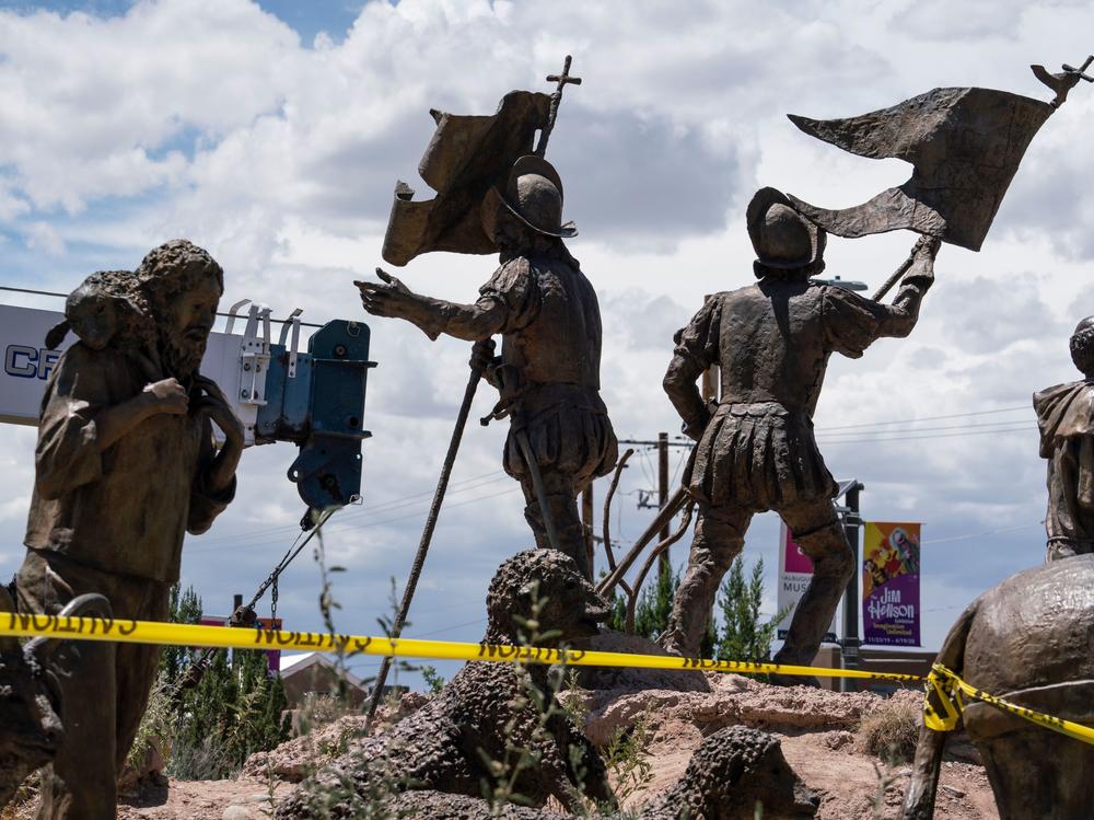 A sculpture of Juan de Oñate's settlers arriving in New Mexico is pictured as city workers remove a sculpture of the Spanish conquistador on June 16 in Albuquerque.