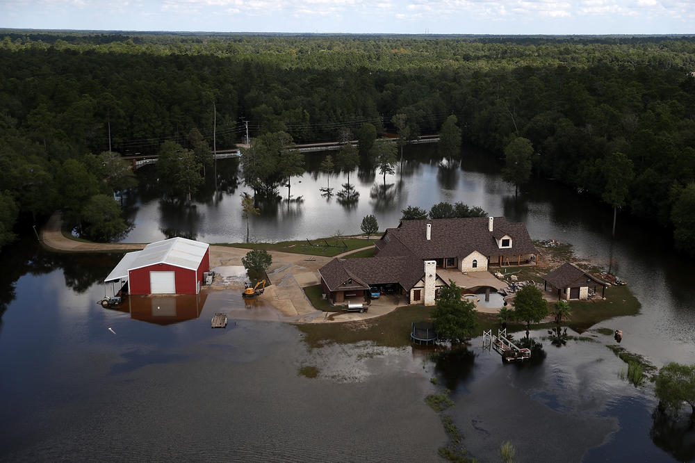 A Beaumont, Texas home surrounded by floodwaters in 2017. Places with less population density or less wealth are often less likely to receive federal flood mitigation funds.