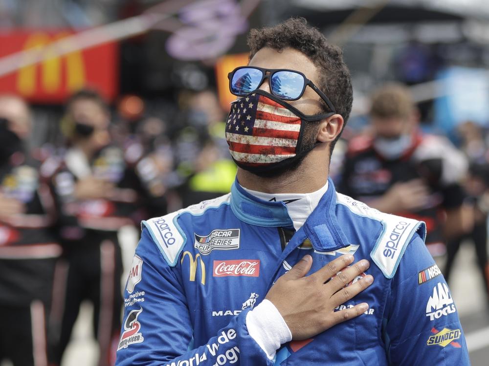 NASCAR Cup Series driver Bubba Wallace stands during the national anthem before a NASCAR auto race Sunday at the Indianapolis Motor Speedway in Indianapolis.