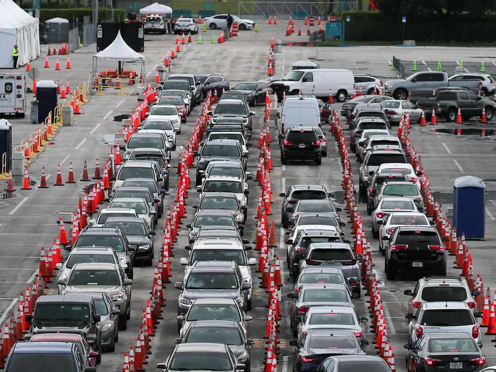 Lines and lines of cars are seen as drivers wait on Monday to be tested for COVID-19 at a coronavirus testing site in Miami Gardens, Fla.