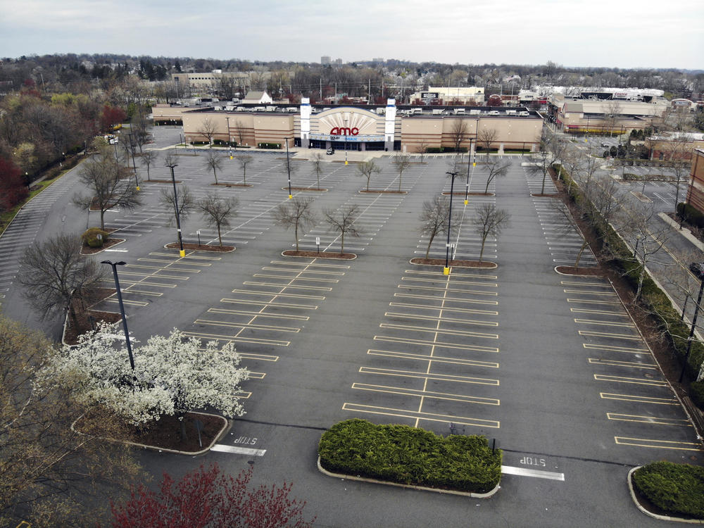 Movie chains are suing to be included in New Jersey's reopening plans. An empty parking lot is seen at an AMC movie theater in Clifton, N.J, on April 5.