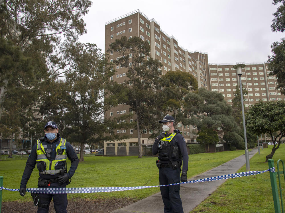 Police guard access to housing commission apartments under lockdown in Melbourne, Australia. The hard-hit Australian state of Victoria recorded two deaths and its highest-ever daily increase in coronavirus cases on Monday as authorities prepare to close its border with New South Wales.