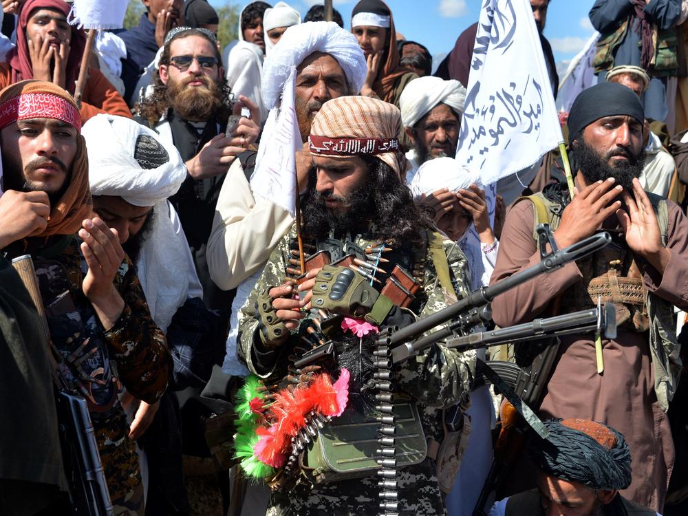 Afghan Taliban militants and villagers celebrate a peace deal and victory in March. News reports allege Russia offered bounties to Taliban-linked militants to kill U.S. troops. Russia accuses U.S. intelligence of leaking the story to scuttle the peace process.