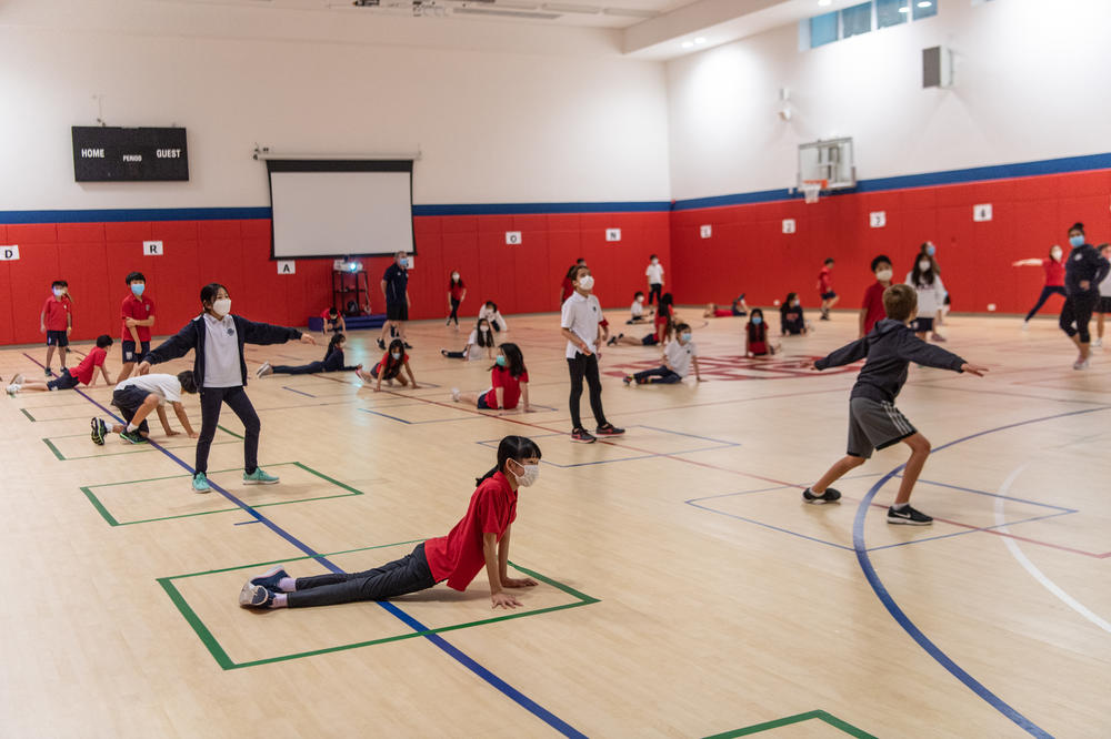 Students strike poses — while keeping a social distance — during a PE class at Hong Kong International School.