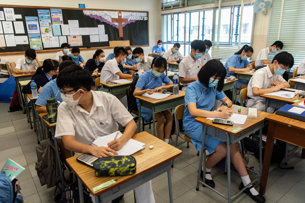 High school students wear masks inside a classroom.