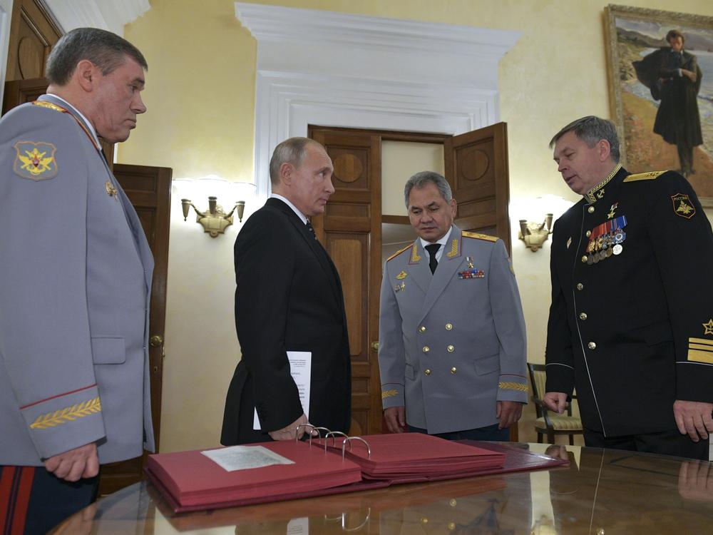 Russian President Vladimir Putin (second from left) meets military officials, including Igor Kostyukov (far right), the deputy chief of military intelligence for the GRU. The 2018 event in Moscow marked the centenary of the GRU, which has been involved in many major operations in recent years. U.S. intelligence suspects the GRU of involvement in a reported bounty program in Afghanistan.