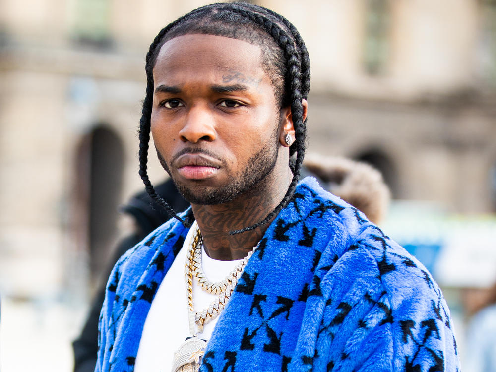 Los Angeles police say they have arrested five people in connection with the February shooting death of rapper Pop Smoke. The late musician is seen here during Paris Fashion Week's men's fall-winter shows in January.