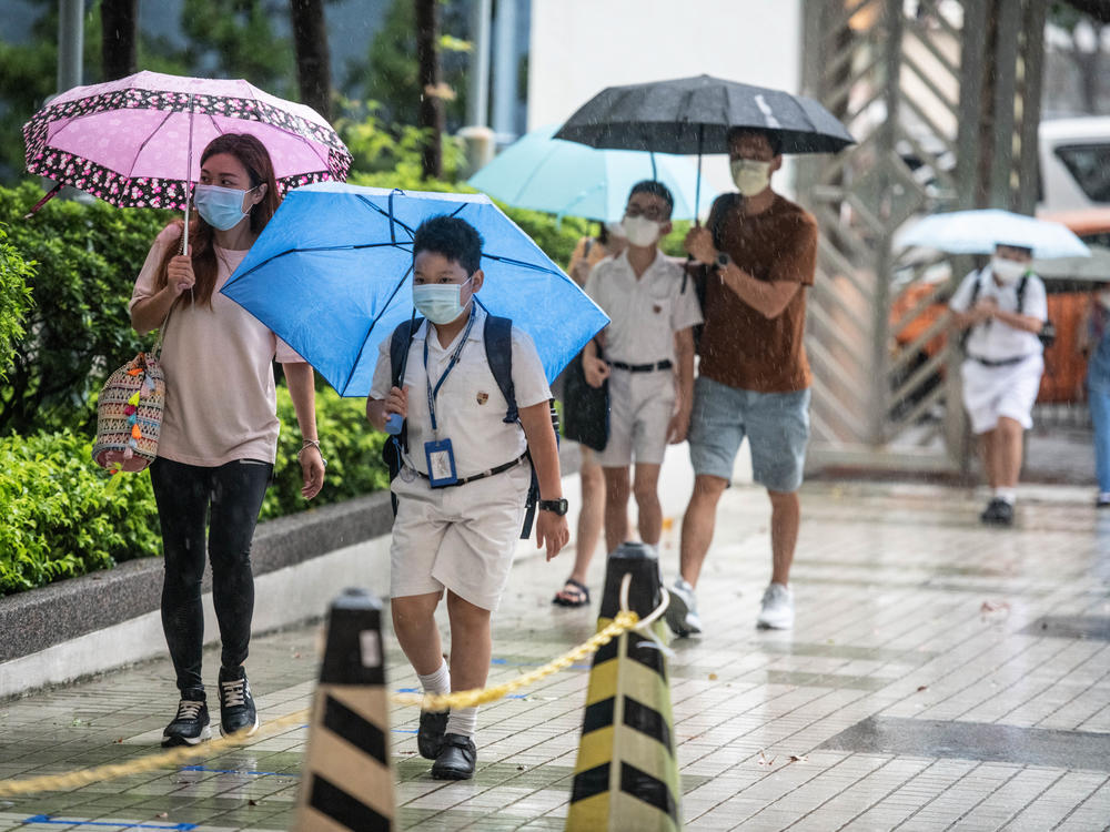 Children arrive at Hong Kong's Maryknoll Fathers' Primary School on June 8, the first day of classes since the COVID-19 outbreak.