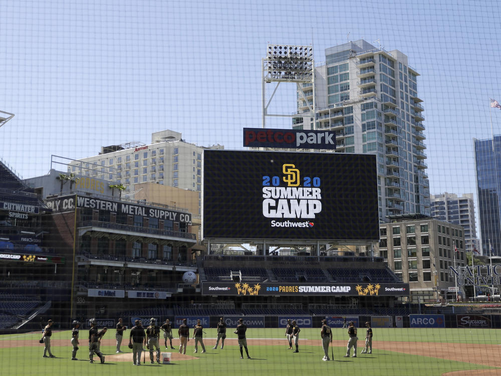 Members of the San Diego Padres meet in the infield during baseball training last week at Petco Park in San Diego. Major League Baseball is taking steps to start the 2020 season amid the coronavirus pandemic.