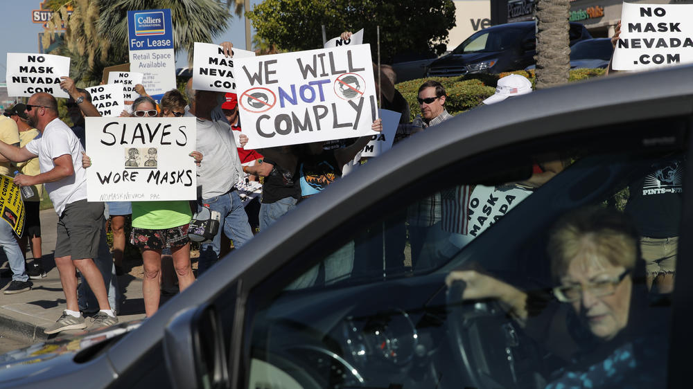 People protest Nevada's public mask mandate Wednesday in Henderson. Gov. Steve Sisolak issued a mandatory face covering policy for public spaces throughout the state due to concerns over the spread of the coronavirus.