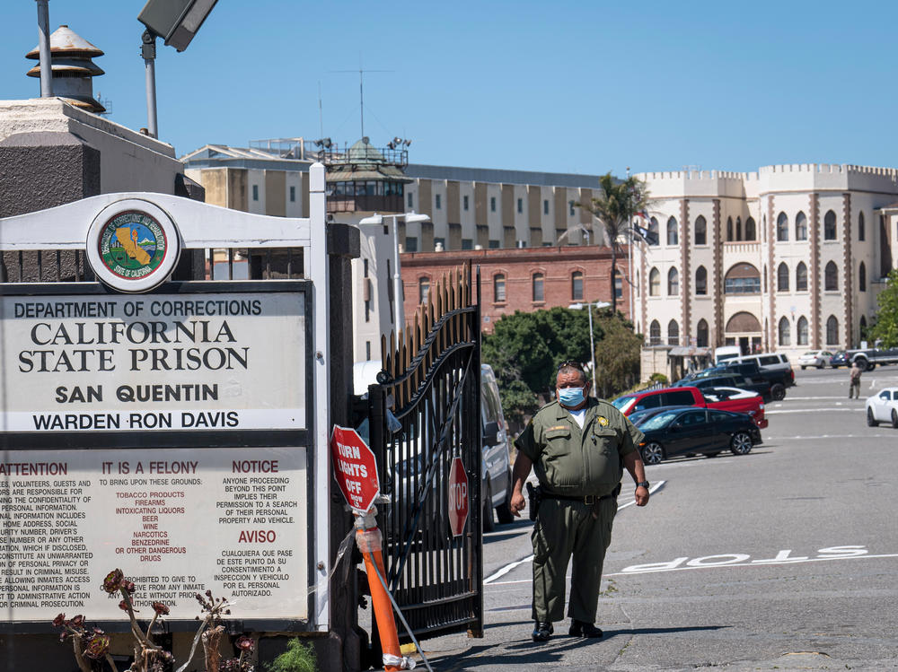 A corrections officer stands guard in late June at San Quentin State Prison. More than a third of the inmates and staff at the prison in the San Francisco Bay Area have tested positive for the coronavirus.