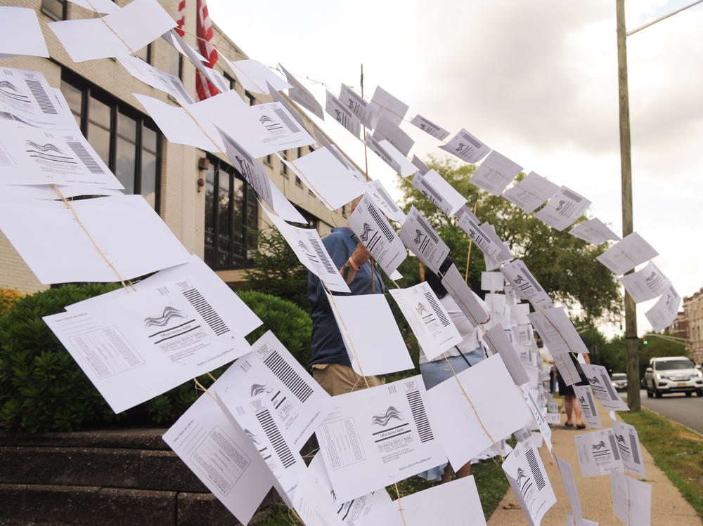 A rally outside the Montclair, N.J., town hall on July 1. Protesters hung 1,101 absentee ballots to represent the number of votes that weren't counted in a mayoral election that was decided by just 195 votes.