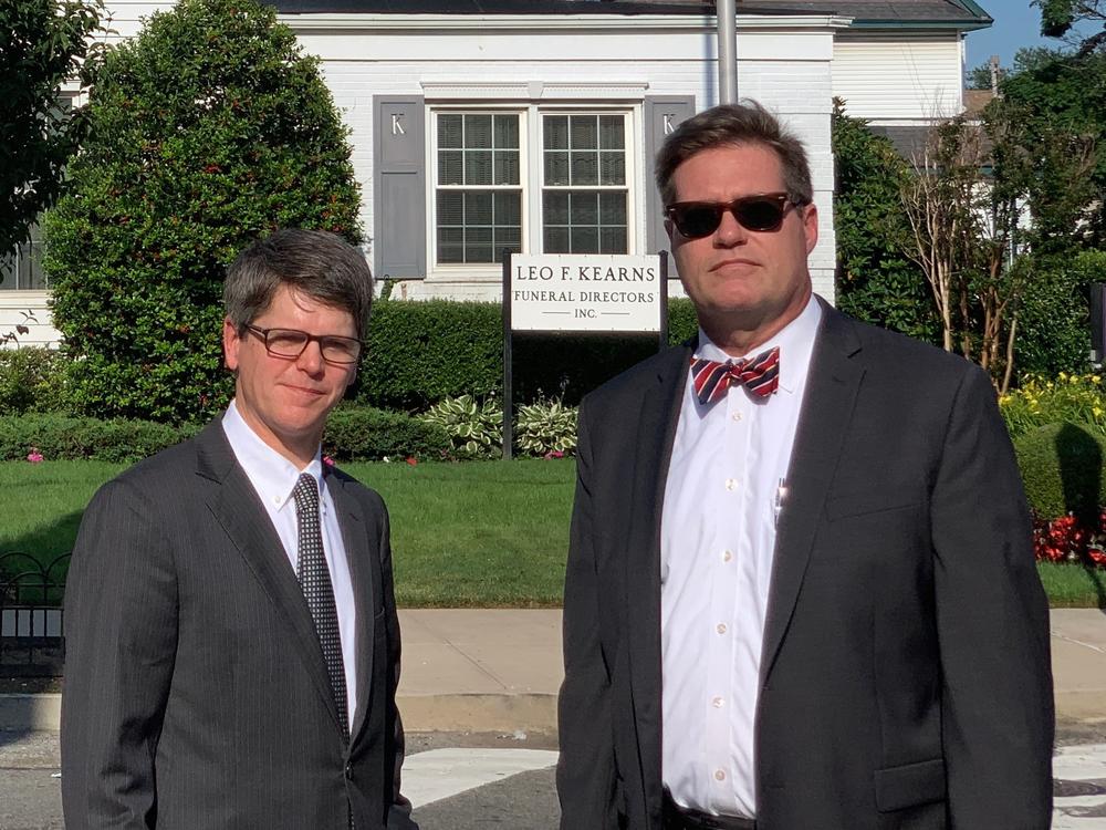 Fourth-generation funeral home director Patrick Kearns (left) and his business partner and brother-in-law Paul Kearns-Stanley stand in front of their funeral home in North Richmond Hill, Queens.