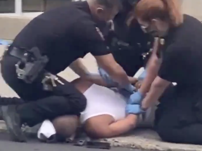 A screenshot from a cellphone video appears to show a police officer pressing his knee into a man's neck, in Allentown, Pa.