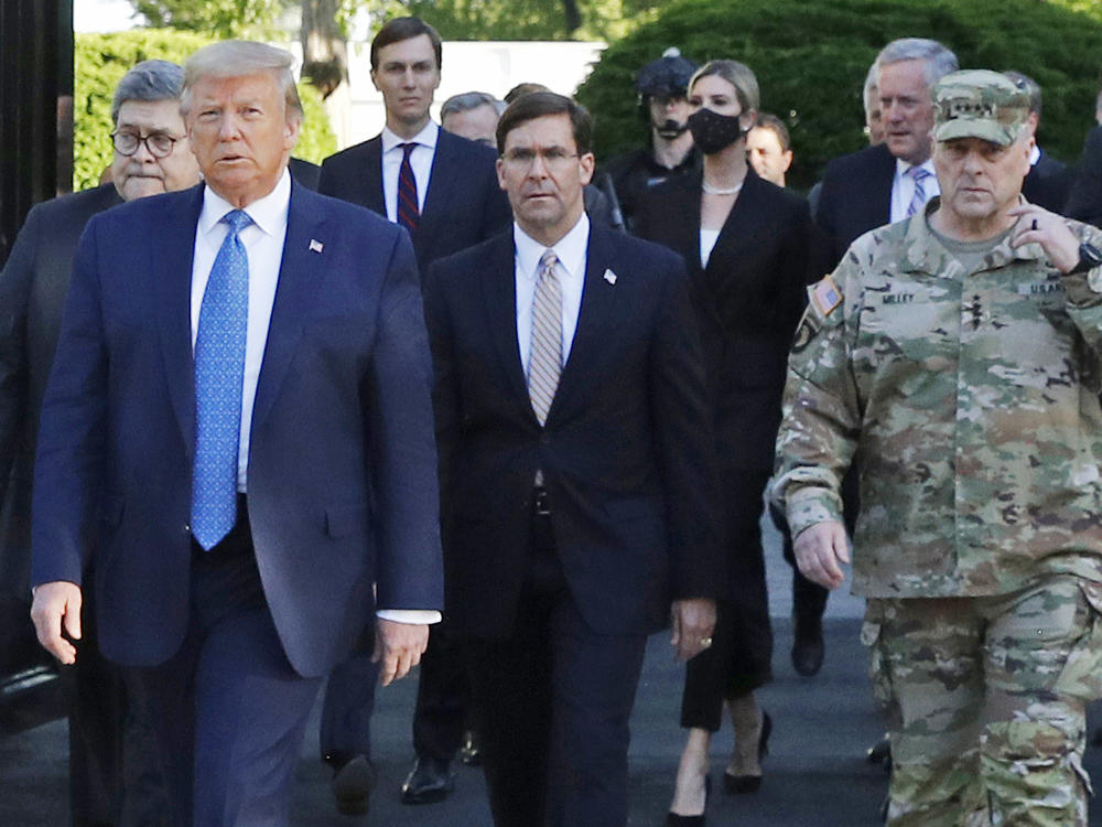 President Trump and his advisers, including Attorney General William Barr, walk through Lafayette Square on June 1 after it was cleared of protesters. Trump then posed for photos holding up a Bible in front of St. John's Episcopal Church.