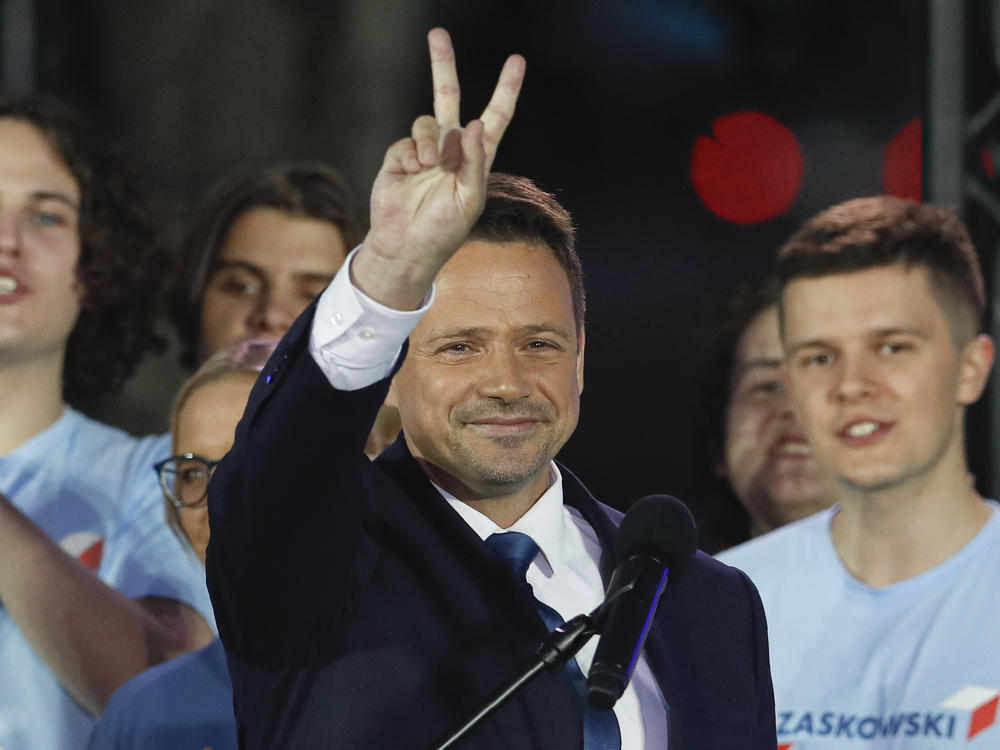 Presidential candidate and Warsaw Mayor Rafal Trzaskowski flashes a victory sign at the end of election day in Warsaw.