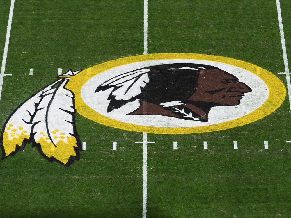 The Washington Redskins' logo is seen before a game in 2019 in Landover, Md. The Redskins have announced the team will be dropping its moniker, which is widely considered a slur against Native Americans.
