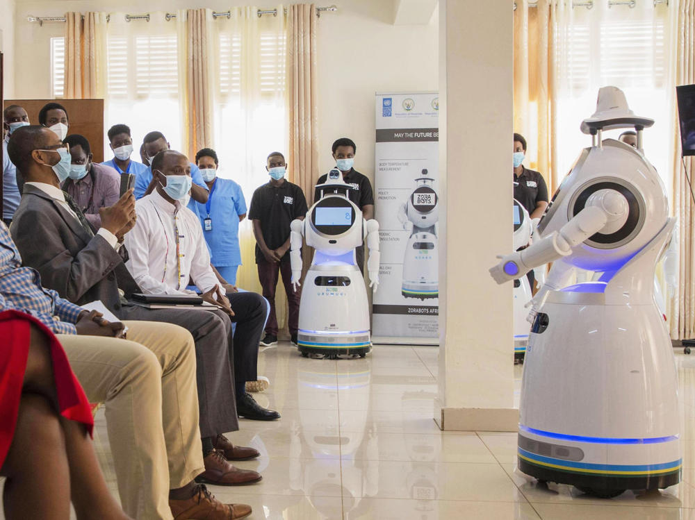 A robot introduces itself to patients in Kigali, Rwanda. The robots, used in Rwanda's treatment centers, can screen people for COVID-19 and deliver food and medication, among other tasks. The robots were donated by the United Nations Development Program and the <a href=