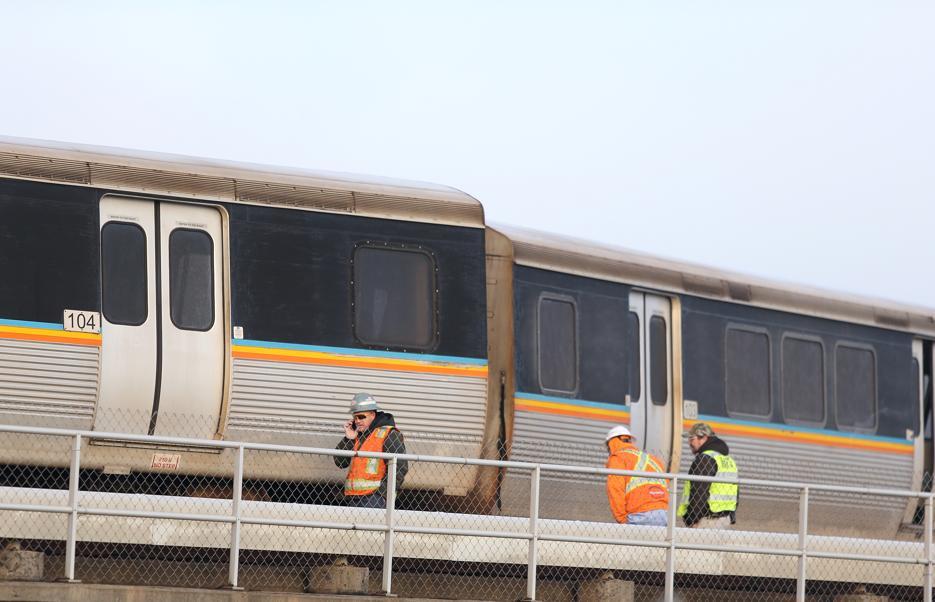 A crane has removed two derailed commuter train cars at Atlanta's airport, but repairs continue on the damaged track.