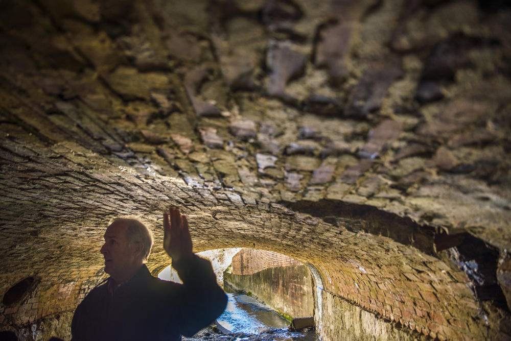 Clay Murphey, program director for special sales tax funded projects in Macon-Bibb County, points out how the stormwater culvert running underneath Second Street and Hazel Street in Macon is in danger of falling in. Murphey wants $30 million on top of the