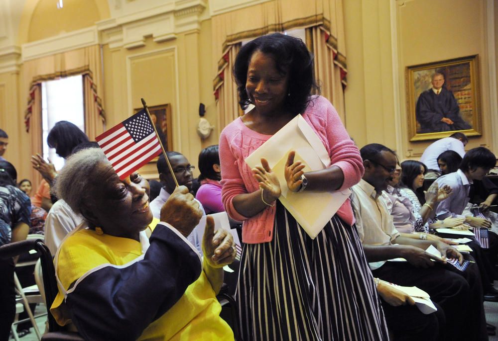 Chritiana Ernest, 89, originally from Haiti, left, celebrates with her daughter Mona Thorington after taking the oath of citizenship at the Bootle Federal Courthouse in Macon in 2012.