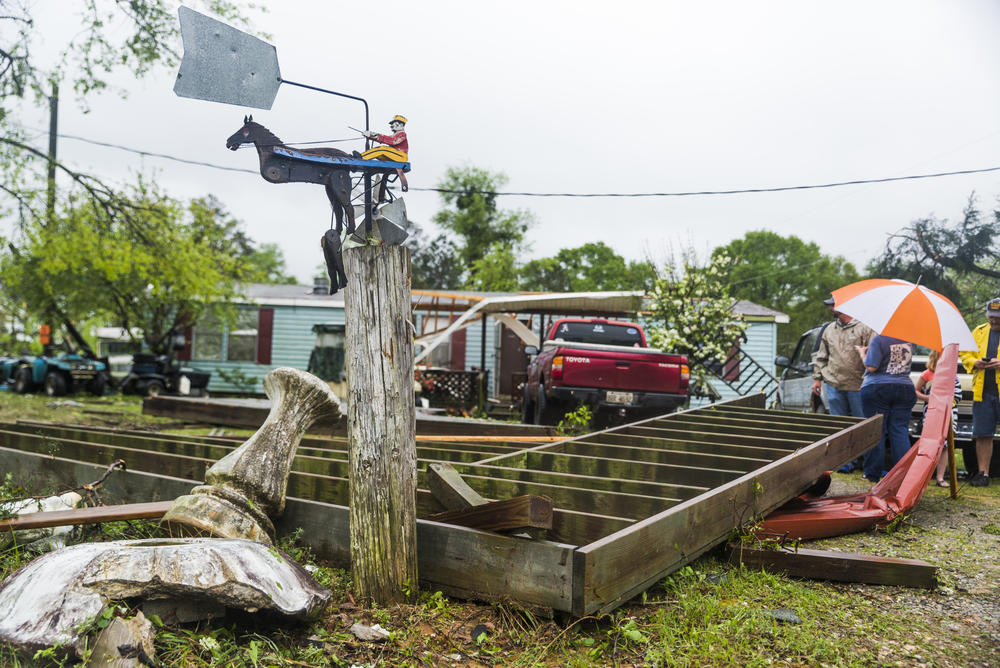 A broken weathervane in the front yard of one of a handful of homes damaged by an apparent tornado in Twiggs County Friday. 