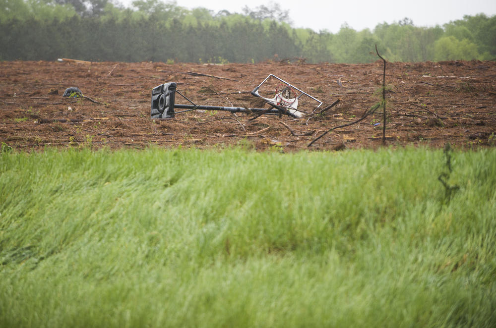 A basketball goal thrown into an empty field near a handful of homes damaged by an apparent tornado in Twiggs County Friday. 