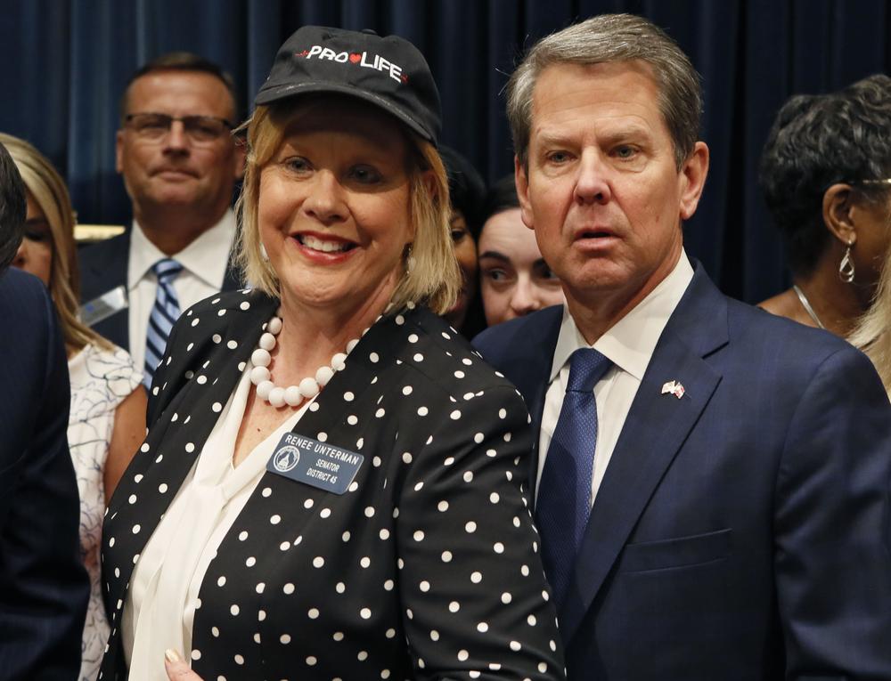 After the signing, Gov. Brian Kemp posed for a photo with Sen. Renee Unterman, R - Buford, and other supporters.  Kemp signed HB 481, the "heartbeat bill," on Tuesday.
