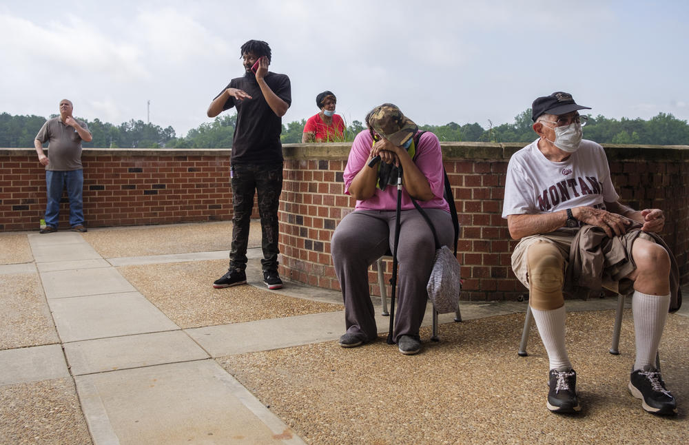 Georgia voters line up out the door in Macon at a polling precinct on June 9, 2020.