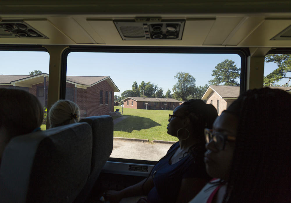 Teachers ride a tour bus through the public housing project known as Bird City in Macon while on a tour of the Hartley Elementary School district. 