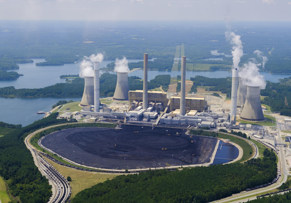 Yellow front end loaders are dwarfed by piled coal in front of Georgia Power's Plant Scherer in Juliette.